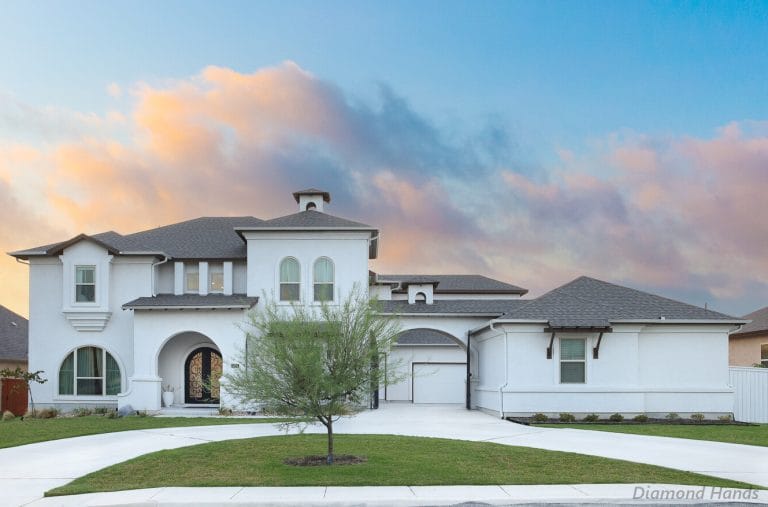 A spacious white house at Randolph Air Force Base serving as a TDY crashpad, featuring a well-maintained lawn, multiple windows, and a welcoming exterior for temporary military lodging and TDY Crashpads.