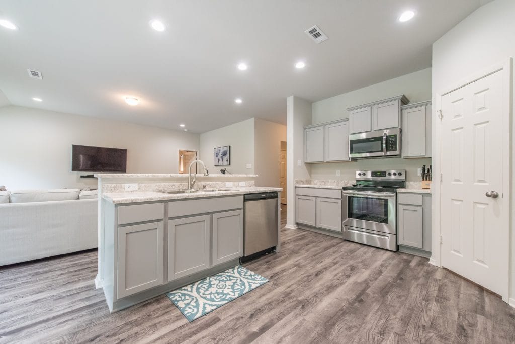 Bright, modern kitchen with stainless steel appliances, granite countertops, and spacious layout | Dream TDY