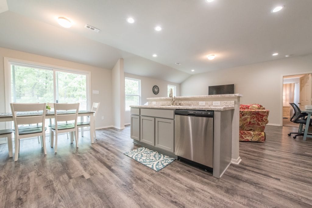 Bright, open living space with modern appliances, cozy seating, and a dedicated workspace | Dream TDY