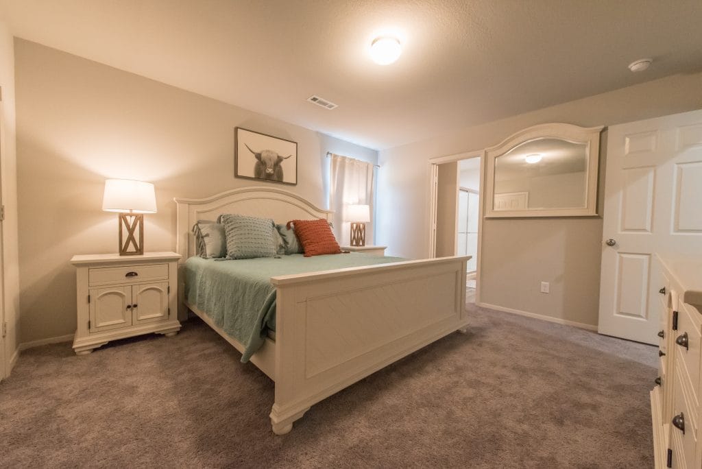 Cozy bedroom featuring plush carpeting, modern furnishings, and serene decor. Ideal for relaxation after a long day | Dream TDY