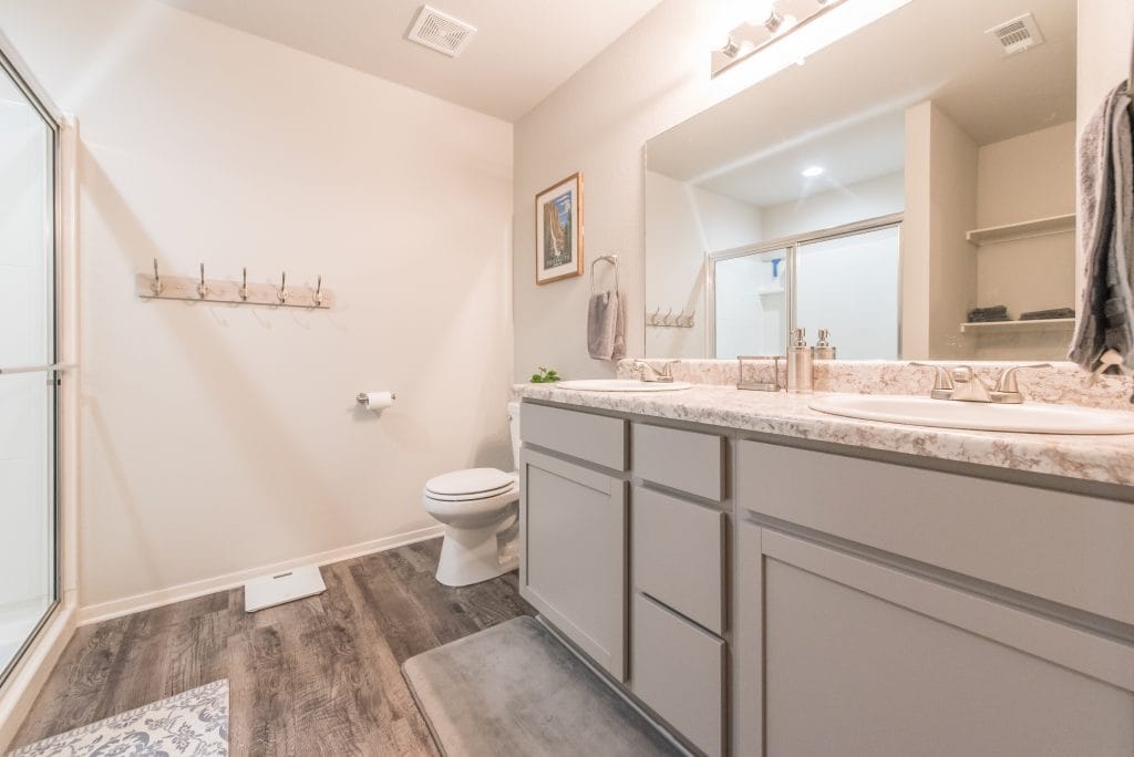 Modern bathroom with dual sinks, sleek cabinetry, and spacious layout. Fresh and clean, perfect for military TDY. | Dream TDY