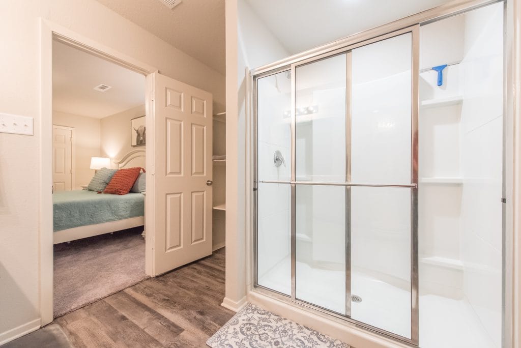 Cozy bedroom with plush bedding, sleek bathroom, and modern finishes, offering a clean and inviting atmosphere | Dream TDY