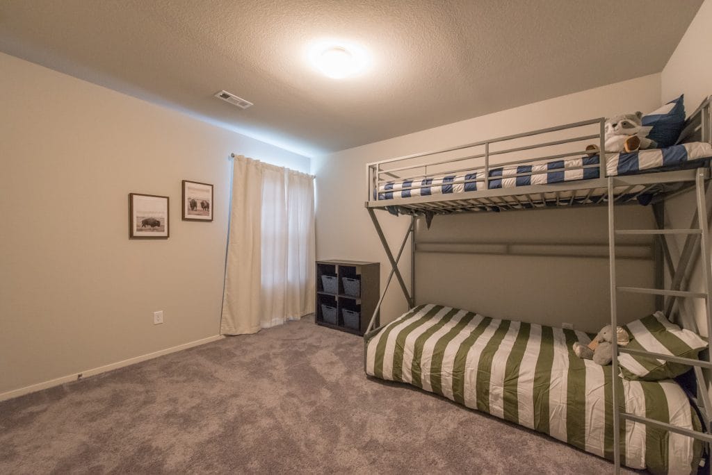 Cozy bedroom with bunk beds, plush carpet, and minimalist decor. Great for relaxation after a long day| Dream TDY