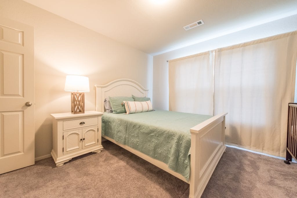 Cozy bedroom with plush carpeting, a serene vibe, modern furnishings, and natural light for a peaceful retreat | Dream TDY