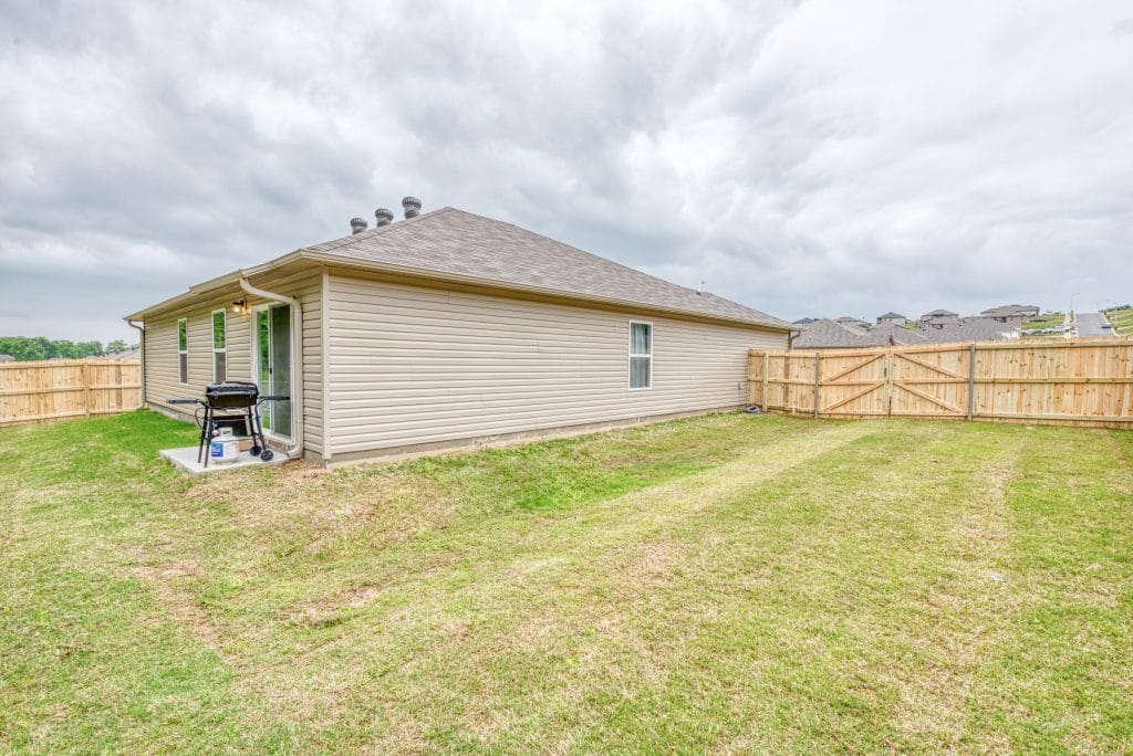 Spacious outdoor space with a private fenced yard and a grill, perfect for relaxation and gatherings | Dream TDY