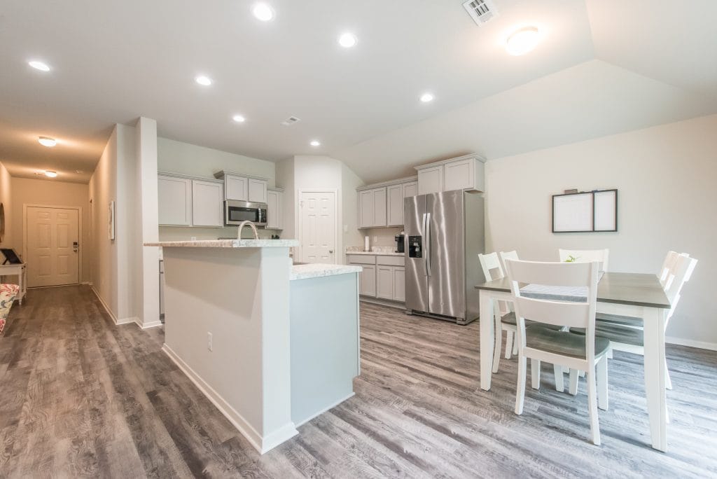 Bright, modern kitchen with sleek appliances, a cozy dining area, and open layout for comfortable living | Dream TDY