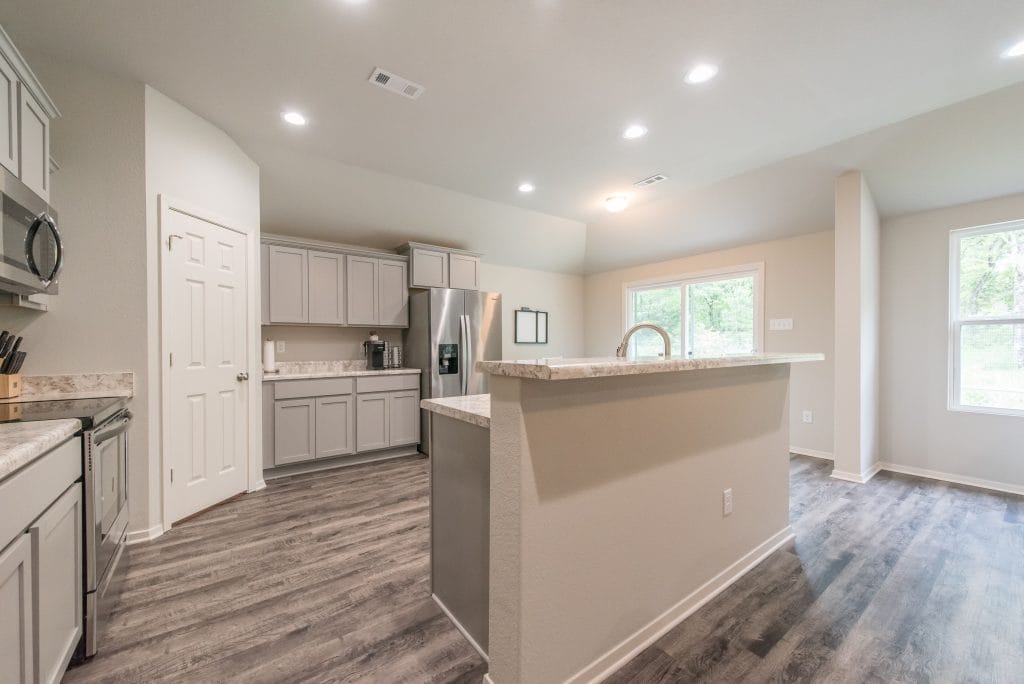 Modern kitchen with sleek gray cabinets, stainless steel appliances, and spacious layout, perfect for meal prep | Dream TDY