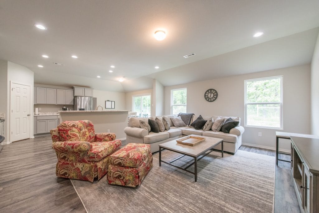 Inviting open living area with cozy sectional, elegant armchairs, and modern appliances. Ideal for relaxation or work | Dream TDY