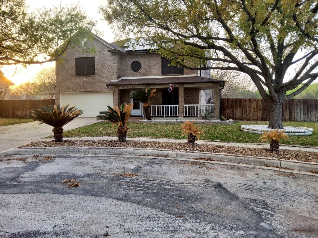 Charming brick exterior with spacious front porch, landscaped yard, and ample parking for comfort and convenience | Dream TDY