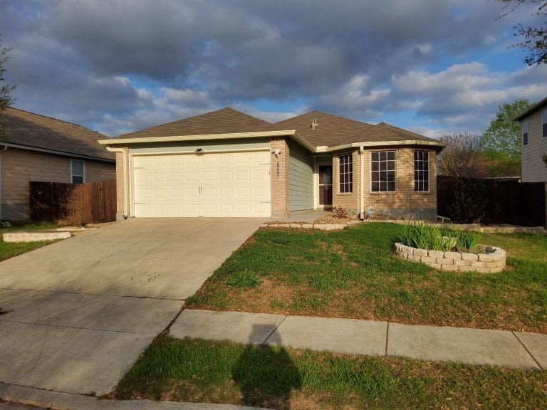 Charming single-story home with a spacious driveway, large windows, and a manicured yard for relaxation | Dream TDY