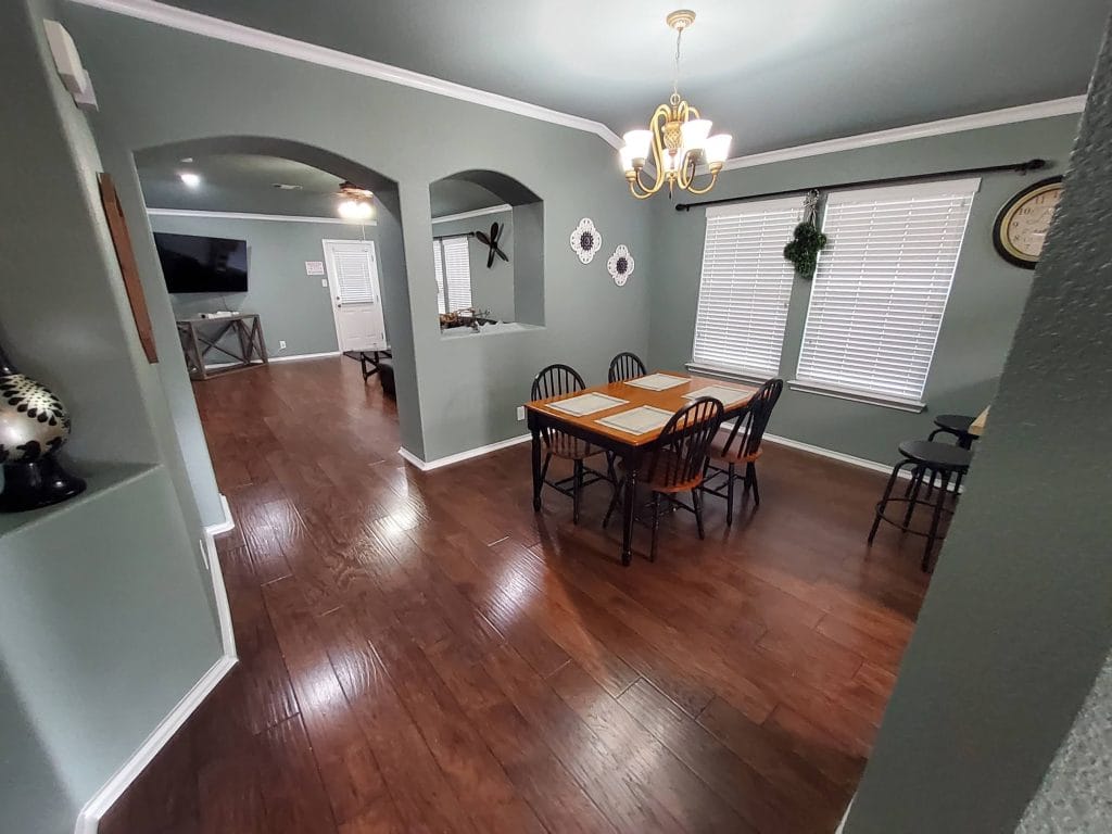 Bright, spacious dining area with elegant lighting, modern wooden flooring, and a cozy atmosphere for family meals | Dream TDY