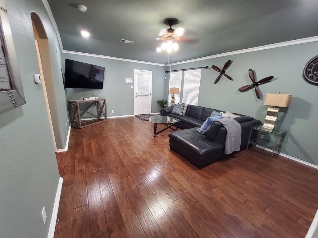 Stylish living room with modern furnishings, ample seating, large TV, and a clean, welcoming vibe | Dream TDY