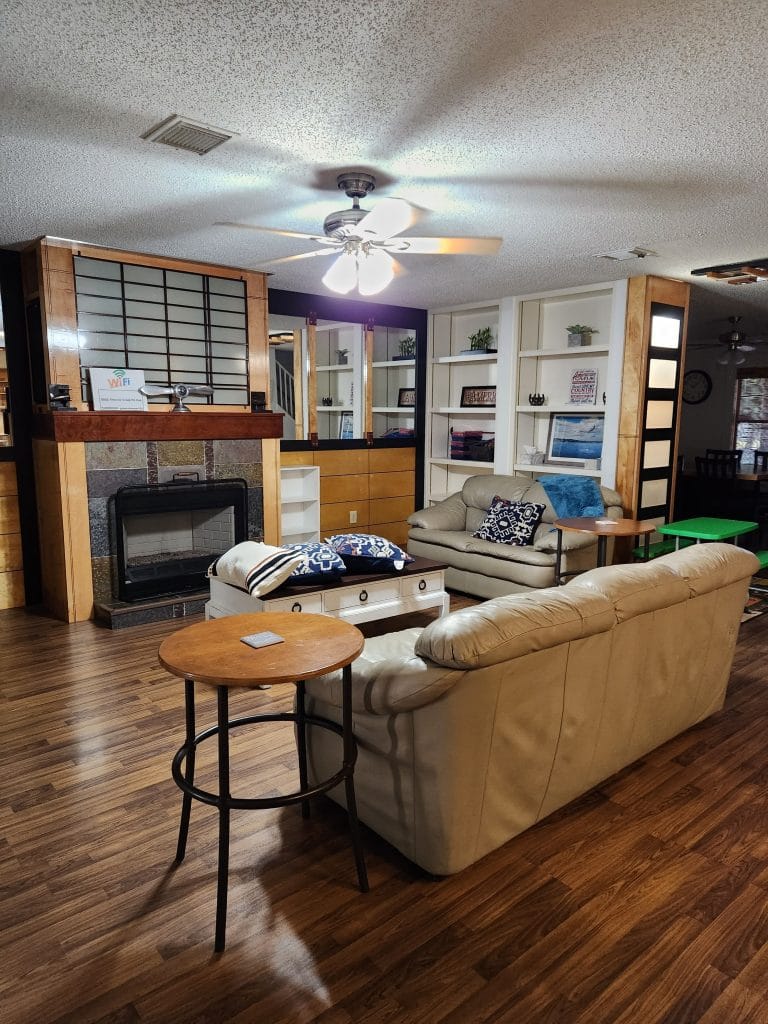 Cozy living area features a stylish leather couch, modern decor, and a fireplace, perfect for relaxation after a long day | Dream TDY