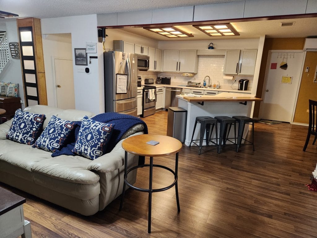 Charming open-concept space with cozy leather seating, modern appliances, and dedicated workspace for your TDY needs | Dream TDY