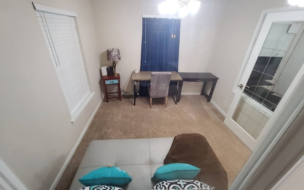 Spacious cozy room with modern desk, plush seating, clean decor, and great lighting for work or relaxation | Dream TDY