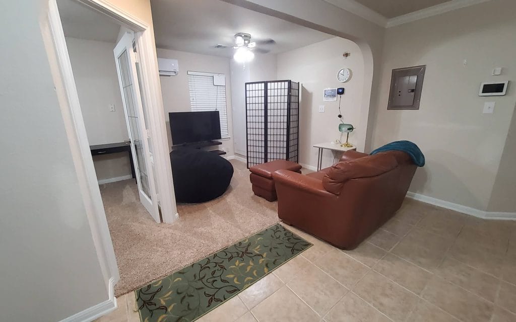 Cozy living area with modern furniture, a dedicated workspace, and clean design; ideal for relaxation or focused work | Dream TDY