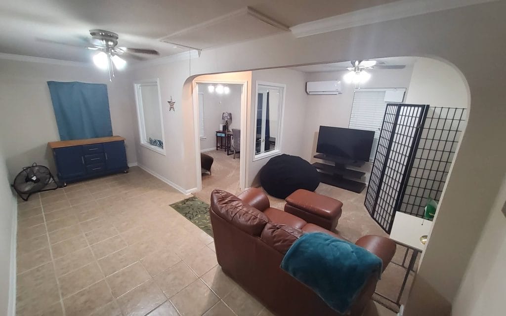 Spacious living area with modern furniture, dedicated workspace, and clean design. Relax or work in comfort | Dream TDY