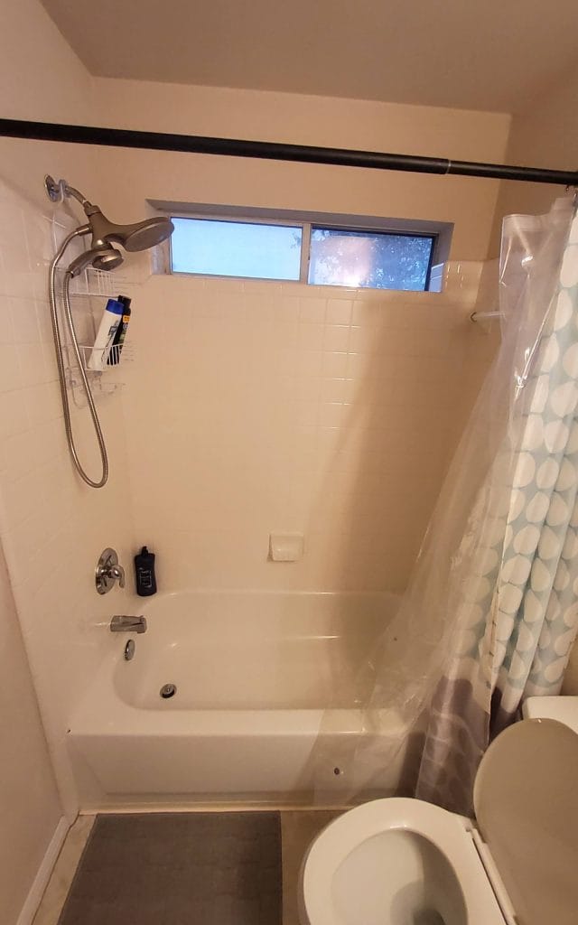 Bright and clean bathroom featuring a relaxing tub and convenient shower, perfect for unwinding after a long day | Dream TDY