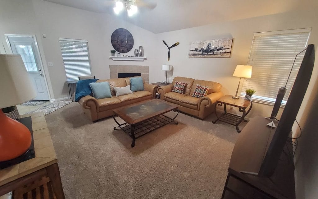 Cozy living area with plush leather sofas, modern decor, and a vibrant ambiance. Perfect for relaxation and productivity | Dream TDY