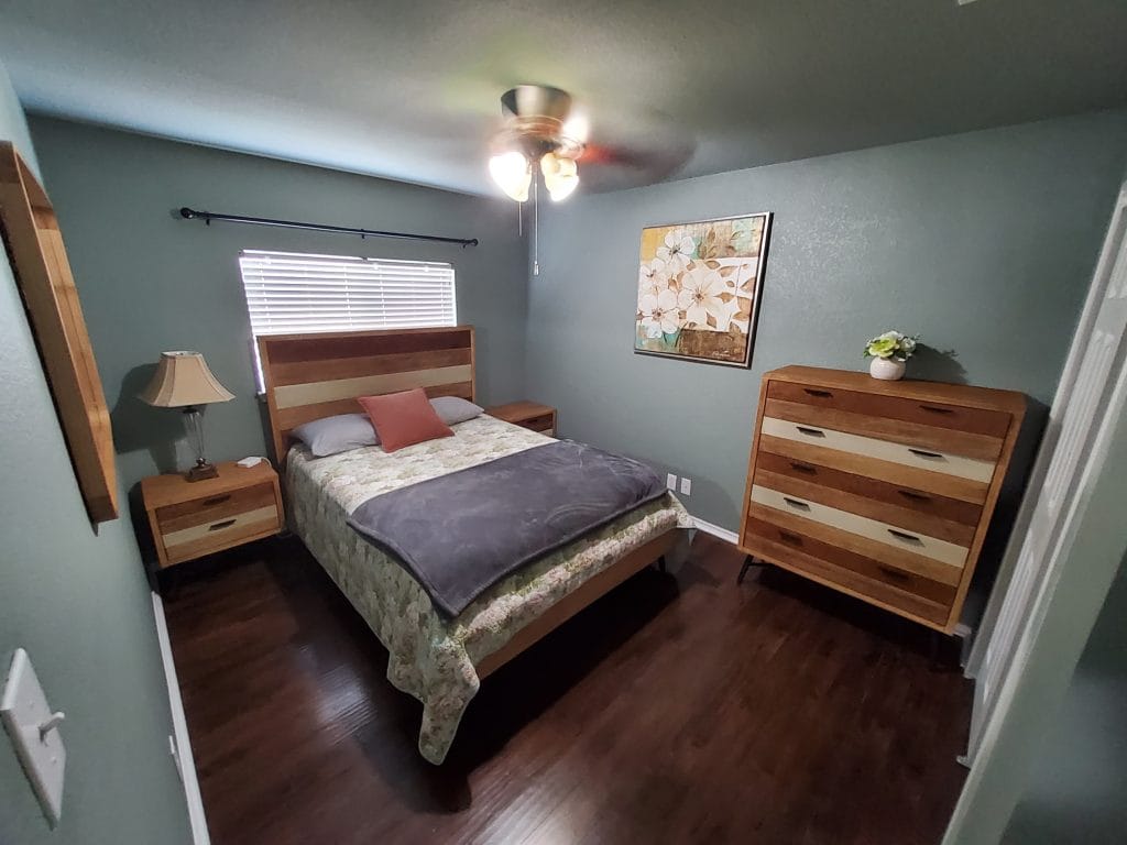 Cozy bedroom with modern furniture, comfortable bedding, and ample storage. Clean space with decorative touches | Dream TDY