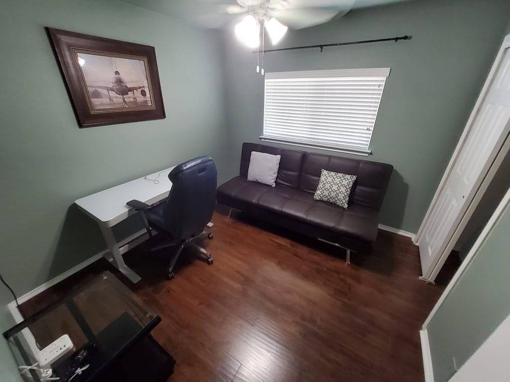 Cozy workspace features a sleek desk, modern chair, and a stylish sofa, all in a clean, well-lit room | Dream TDY