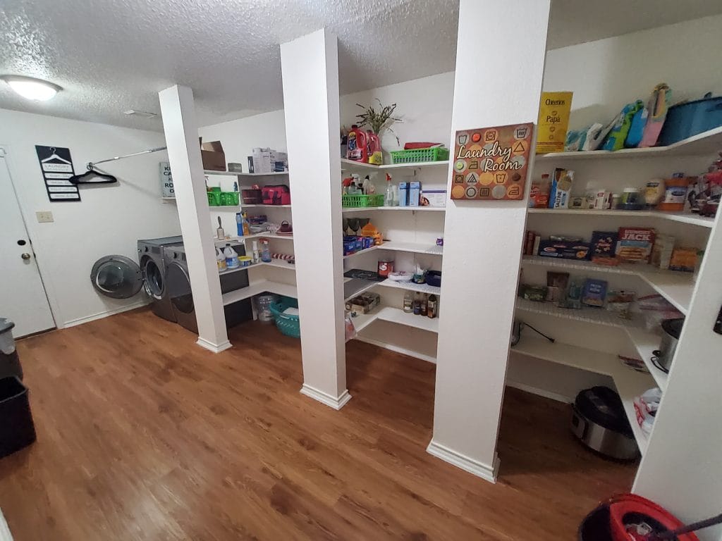 Spacious laundry room equipped with modern appliances and ample shelving for storage, ensuring convenience and organization | Dream TDY