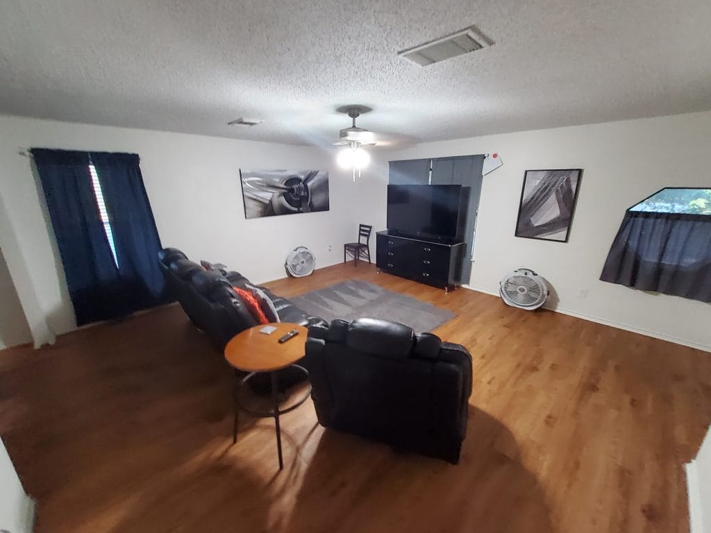 Spacious living area with modern furniture, cozy seating, dedicated workspace, and sleek TV. Ideal for relaxation | Dream TDY