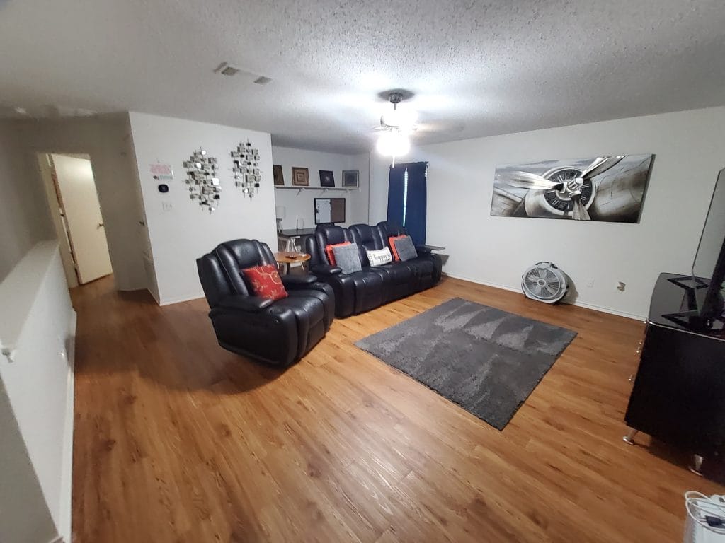 Cozy living space with plush leather seating, modern decor, hardwood floors, and ample natural light | Dream TDY