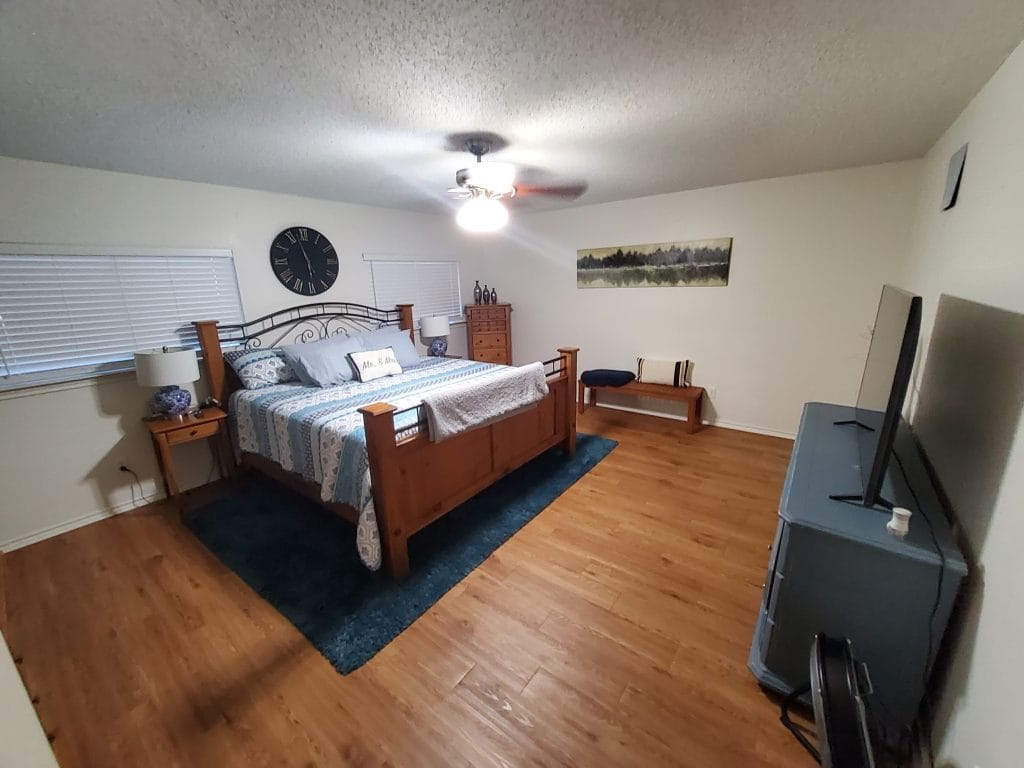 Spacious bedroom featuring a cozy king bed, modern decor, a dedicated workspace, and ample natural light | Dream TDY