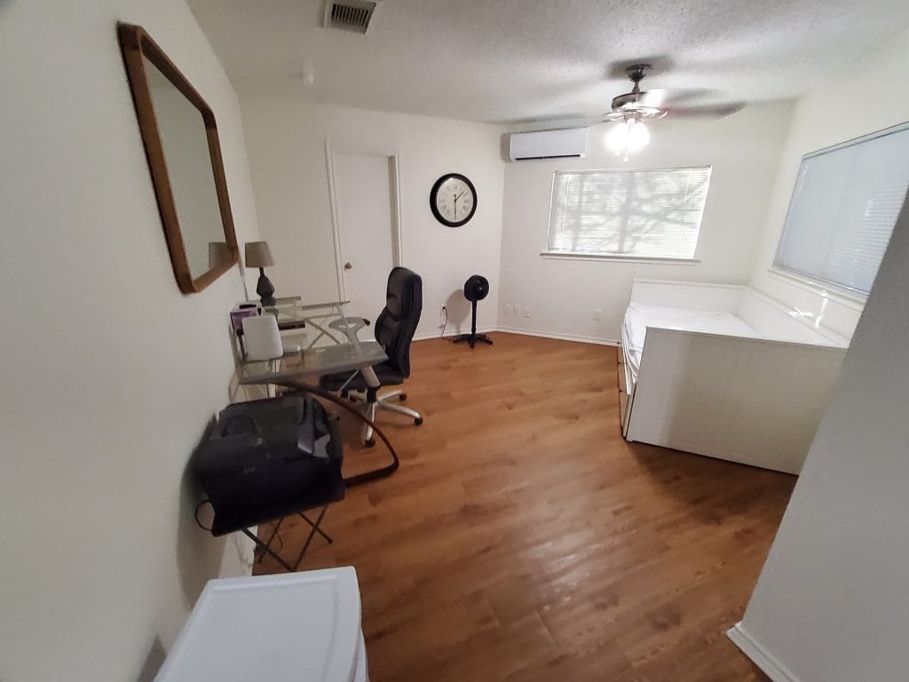 Spacious, clean room featuring modern furniture, a dedicated workspace, and ample natural light | Dream TDY