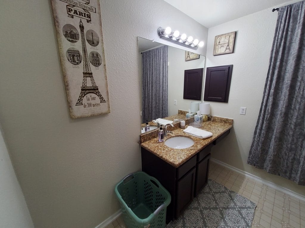 Spacious bathroom featuring elegant granite counters, modern fixtures, and practical décor for a comfortable stay | Dream TDY