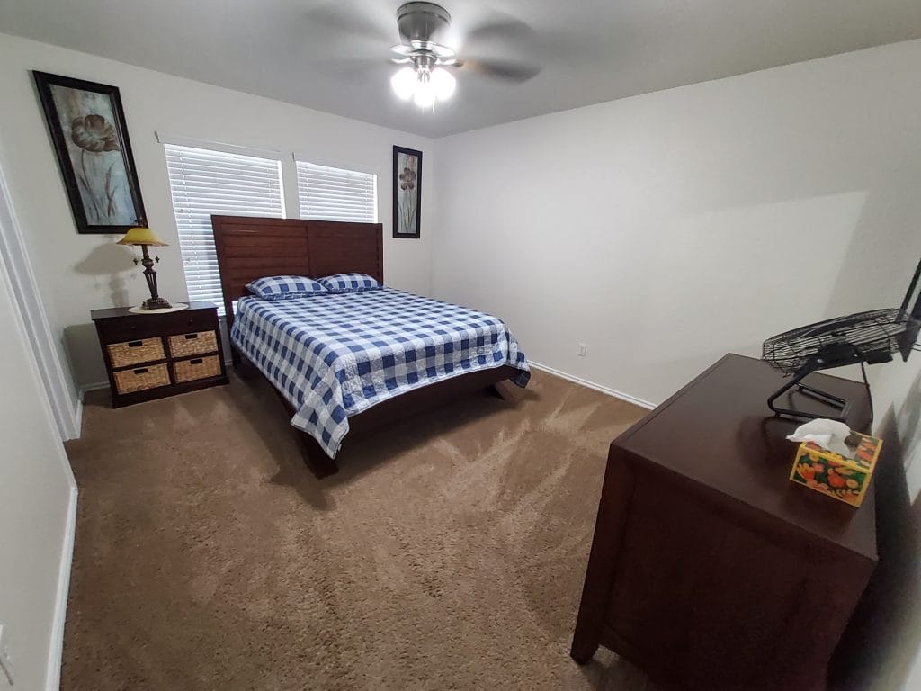 Cozy bedroom featuring a queen bed, plush carpet, stylish decor, and ample storage. Perfect for relaxation and focus | Dream TDY