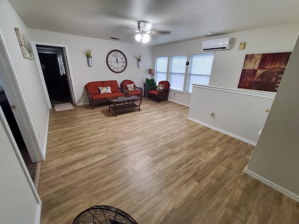 Spacious living area with modern décor, comfortable seating, and ample natural light. Perfect for relaxation or work | Dream TDY