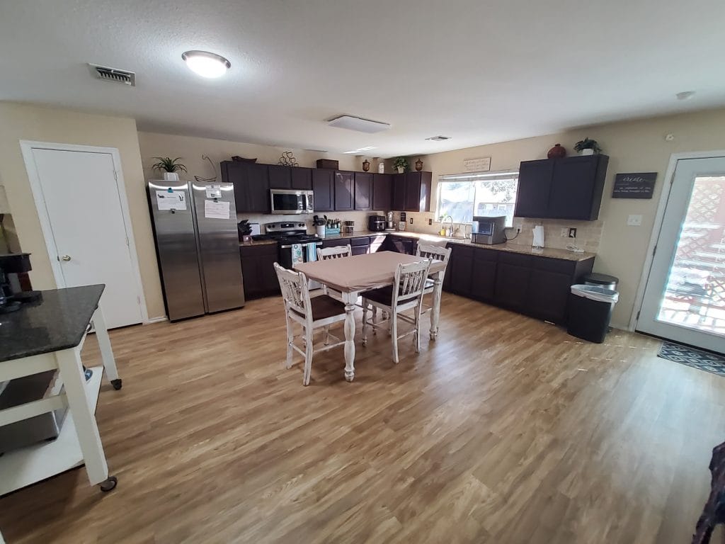 Bright and airy kitchen featuring modern appliances, spacious dining area, and sleek wooden floors | Dream TDY