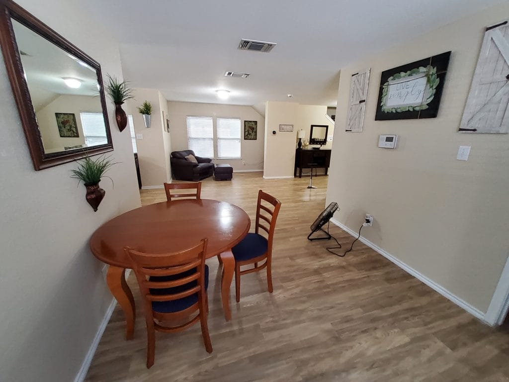 Open living space featuring a cozy dining area, modern appliances, and stylish decor, perfect for a short stay | Dream TDY