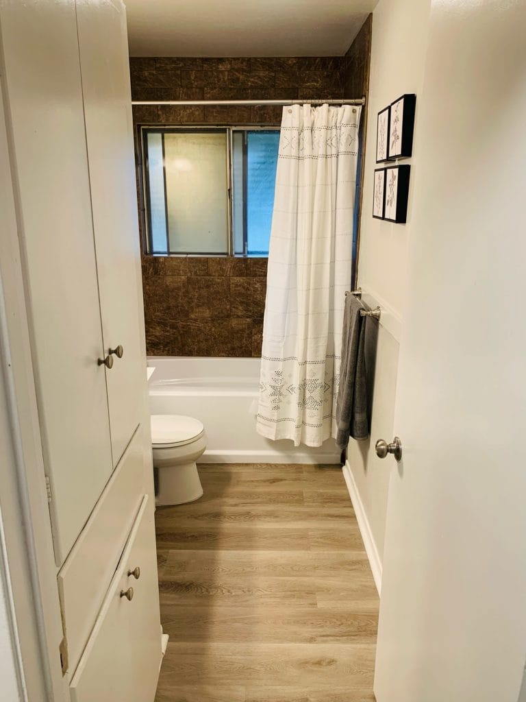 Bright, clean bathroom featuring modern fixtures, stylish decor, ample storage, and a relaxing tub shower combo | Dream TDY
