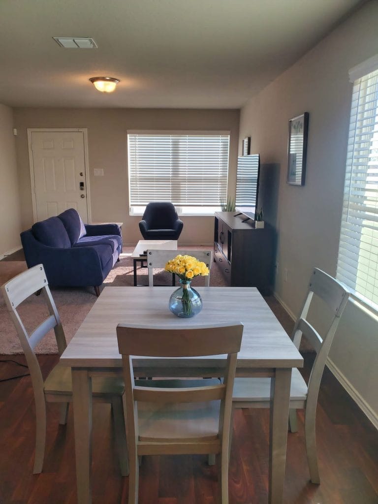 Bright and cozy living area featuring modern furniture, dedicated workspace, and clean amenities for a comfortable stay | Dream TDY