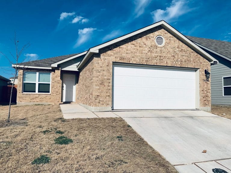 Well-maintained brick exterior with an inviting entrance, ample parking, and a spacious yard, perfect for military families | Dream TDY