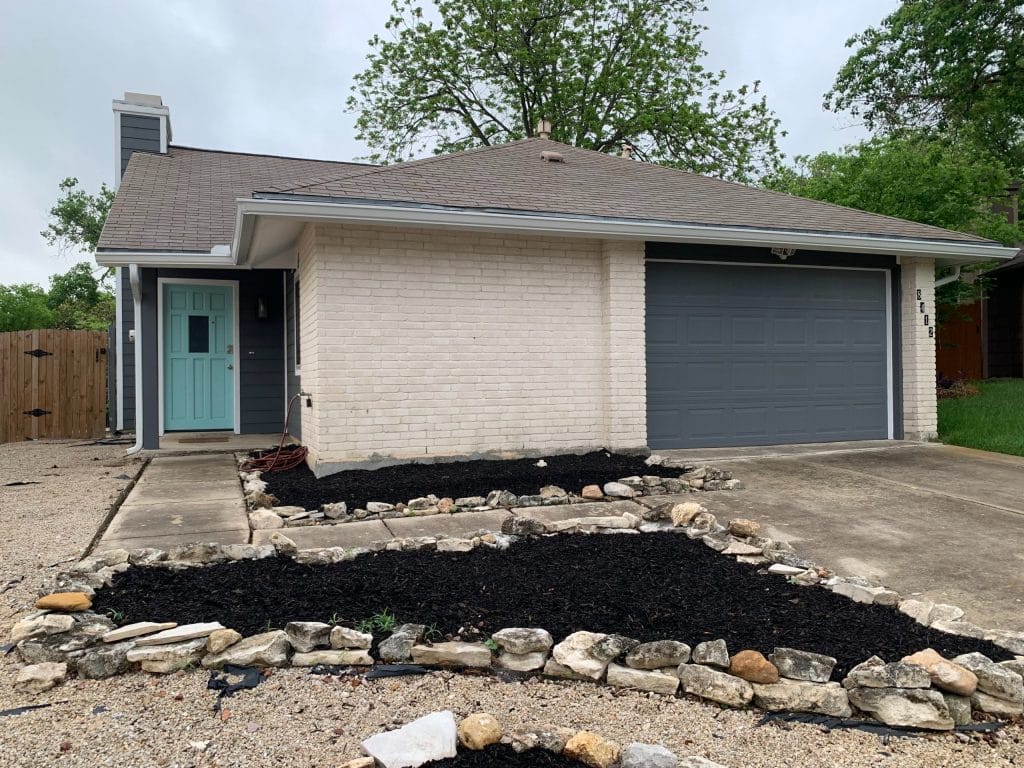 Stylish brick exterior with modern blue accents, landscaped yard, and a spacious garage perfect for short-term military stays | Dream TDY