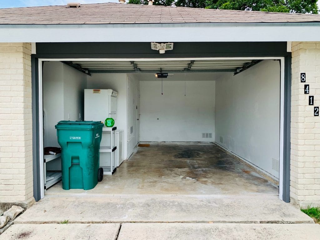 Spacious garage with ample storage, featuring aclean layout, washer, and utility shelf for convenience | Dream TDY