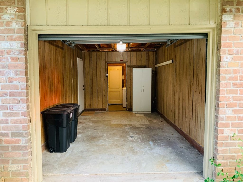 Spacious garage with ample storage, organized bins, and easy access to indoor utilities | Dream TDY