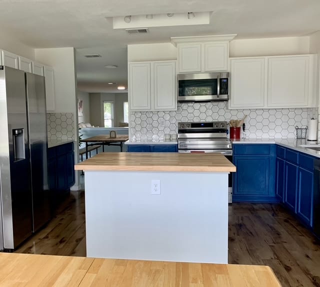 Bright, modern kitchen with stainless appliances, butcher block island, and clean, stylish cabinetry for a comfortable stay | Dream TDY