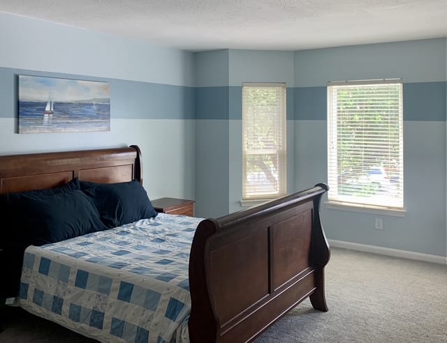 Cozy bedroom with elegant wood furniture, natural light, and a dedicated workspace for productivity | Dream TDY