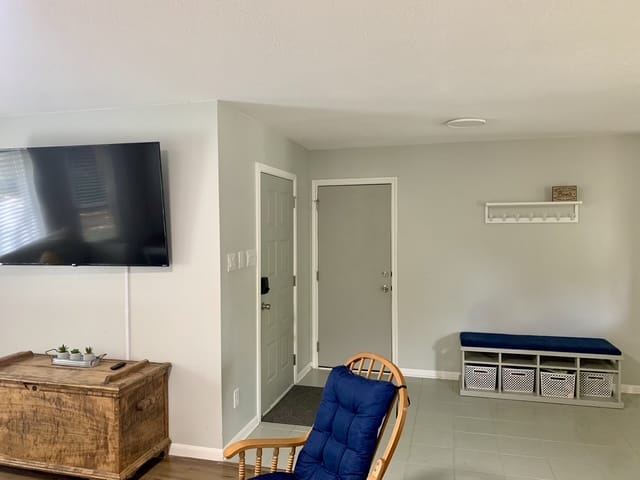 Bright and inviting living space featuring cozy seating, a large TV, clean lines, and modern amenities | Dream TDY