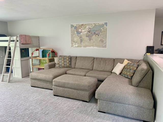 Cozy family-friendly space with a spacious sectional sofa, fun play area, and clean decor. Perfect for relaxation or work | Dream TDY