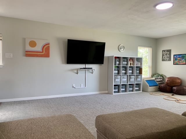 Bright and spacious living area with cozy seating, modern TV, and ample storage. Perfect for relaxation and productivity | Dream TDY