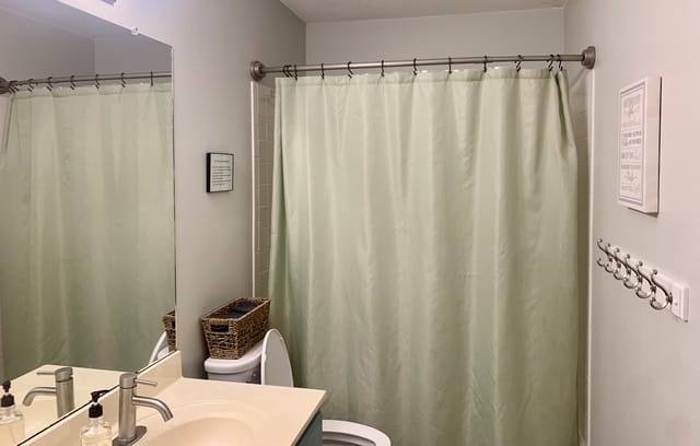 Modern, clean bathroom with a spacious vanity, ample storage, and a calming color palette | Dream TDY