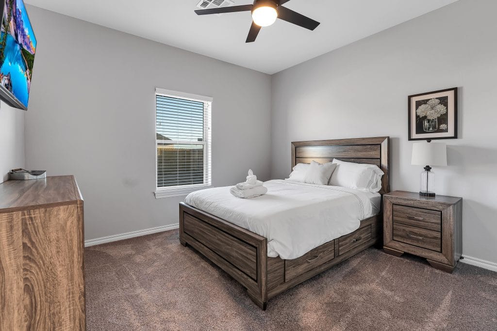 Cozy bedroom featuring a spacious bed, modern furniture, clean ambiance, and ample natural light for a relaxing stay | Dream TDY 