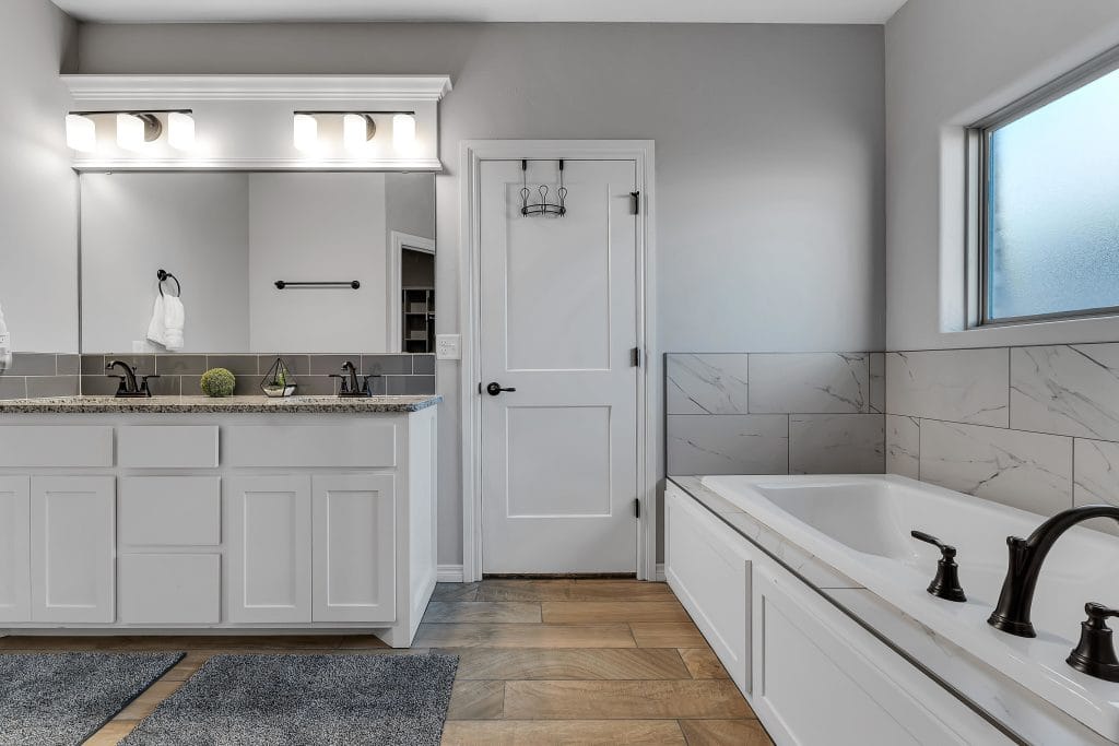 Sleek bathroom featuring dual sinks, relaxing tub, modern fixtures, and stylish tile. A perfect space for unwinding | Dream TDY 