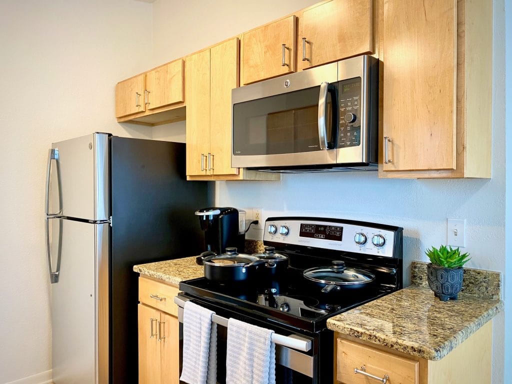 Modern kitchen with stainless appliances, ample counter space, and clean design for a convenient cooking experience | Dream TDY